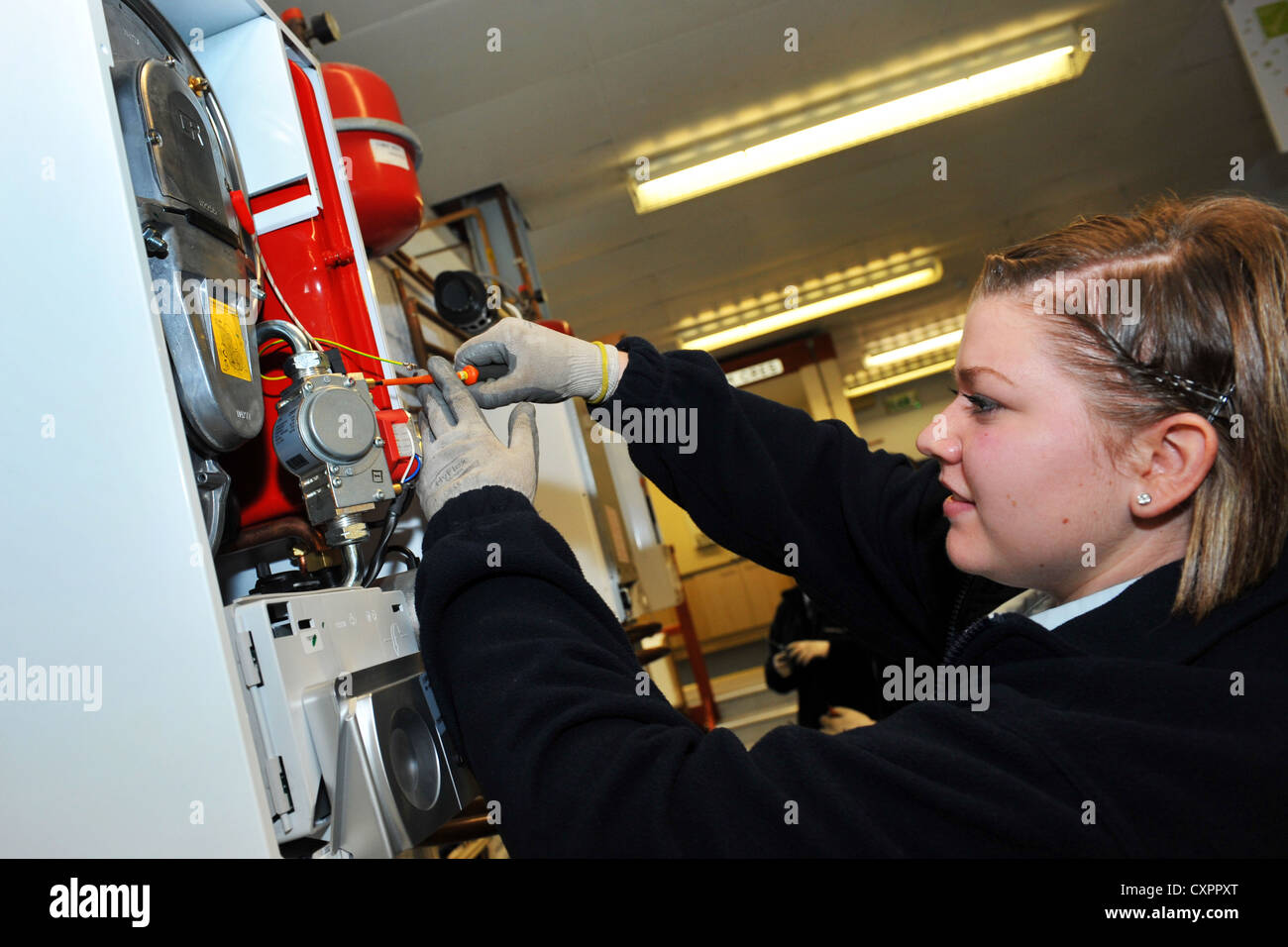 Apprentice working for a Power Company training to be a technician Stock Photo