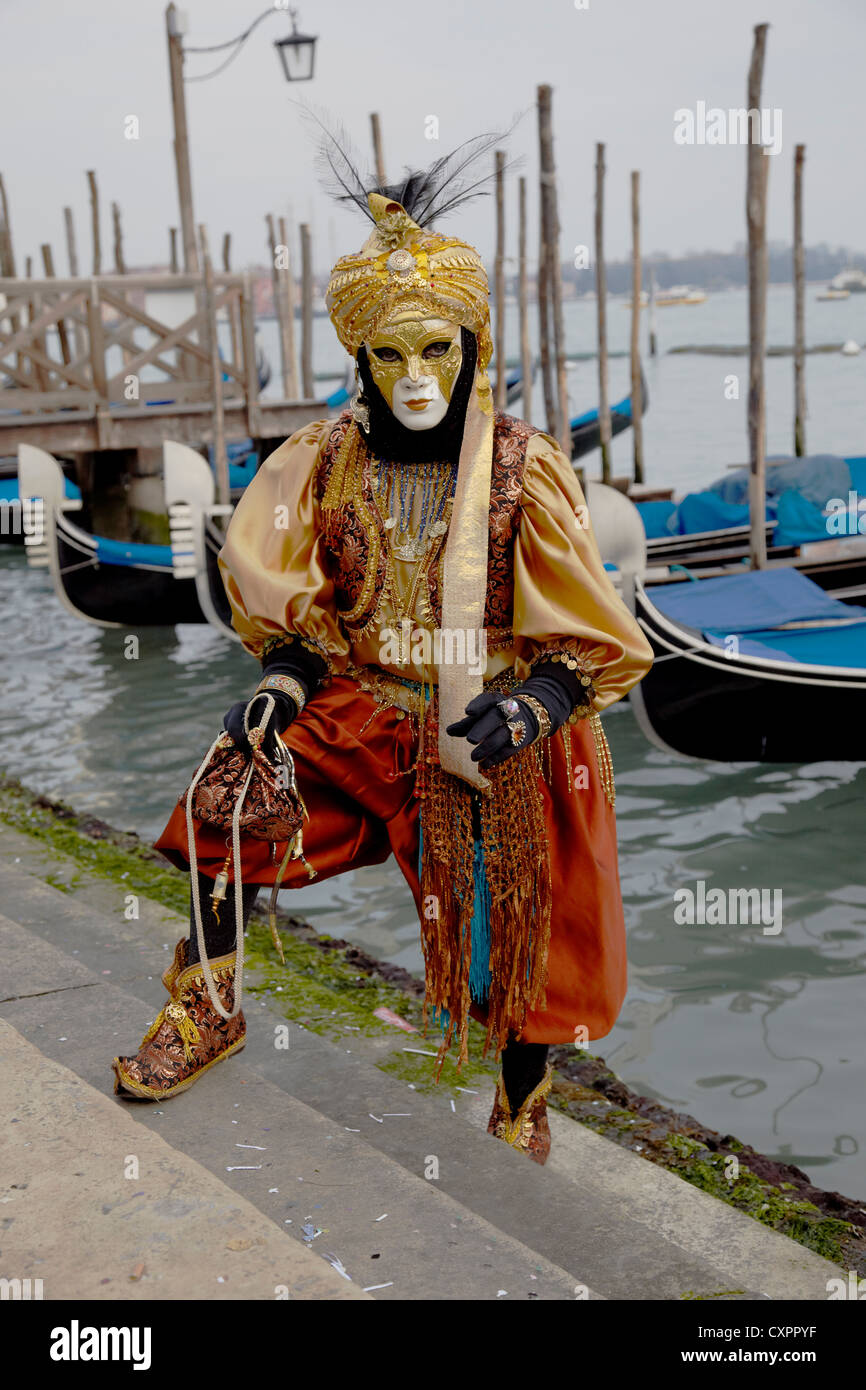 Masquerade posing in front of Gondolas Stock Photo