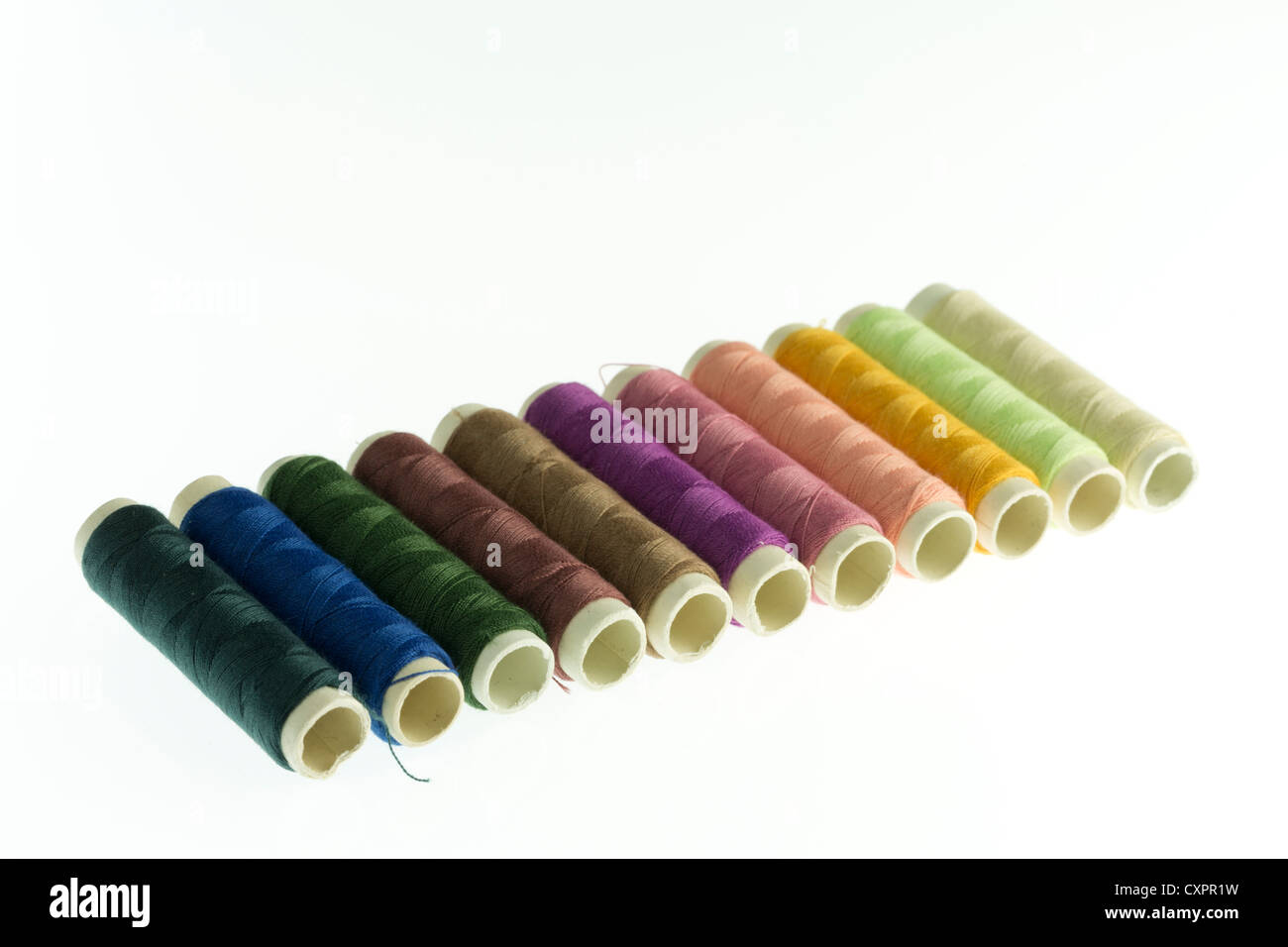 Row of reels of coloured polyester thread Stock Photo