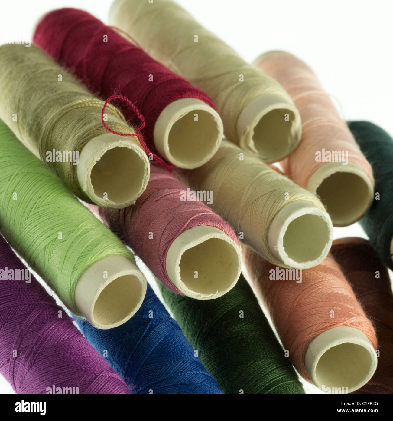 Pile of reels of coloured polyester thread Stock Photo