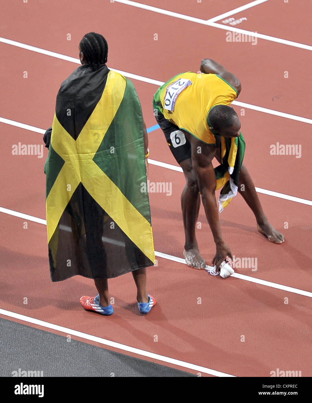 Jamaica's Usain Bolt Picks up the shoe he dropped. Stock Photo