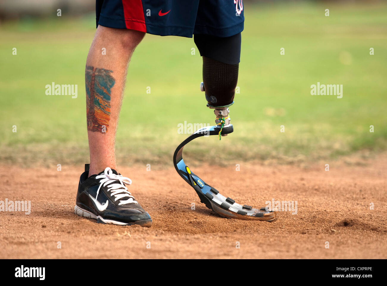A US Army veteran playing for the Wounded Warrior Amputee Softball Team positions himself to strike the ball October 1, 2012 at Millican Field, Joint Base Pearl Harbor-Hickam. The WWAST consists of veterans and active duty service members who have lost their limbs during their service. Stock Photo