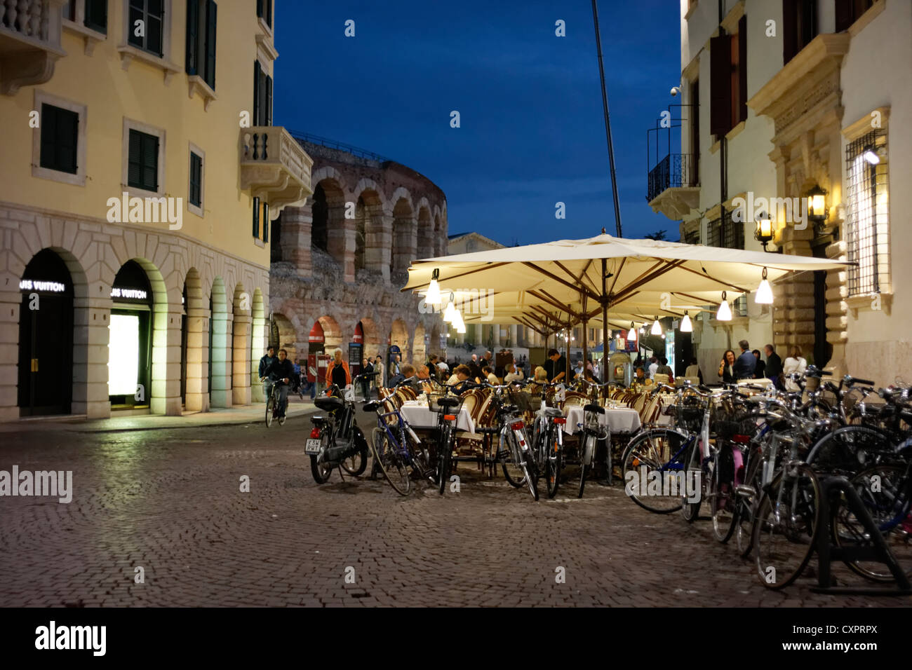 Sidewalk restaurants in Verona, Italy. In front of the Roman Amphitheater Stock Photo