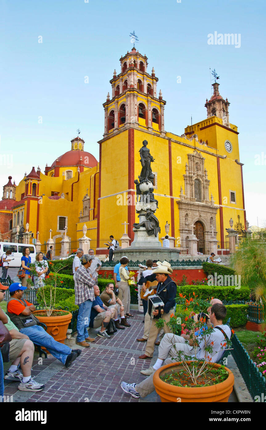 Guanajuato's Plaza de la Paz with musicians attracting a crowd, Basilica of Our Lady of Guanajuato in background Stock Photo