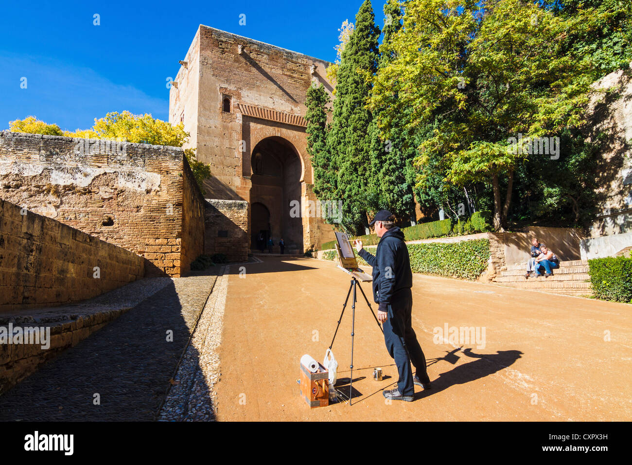 Painter by the Puerta de la Justicia or Justice Gate at the entrance of the Alhambra palace in Granada, Andalusia, Spain Stock Photo