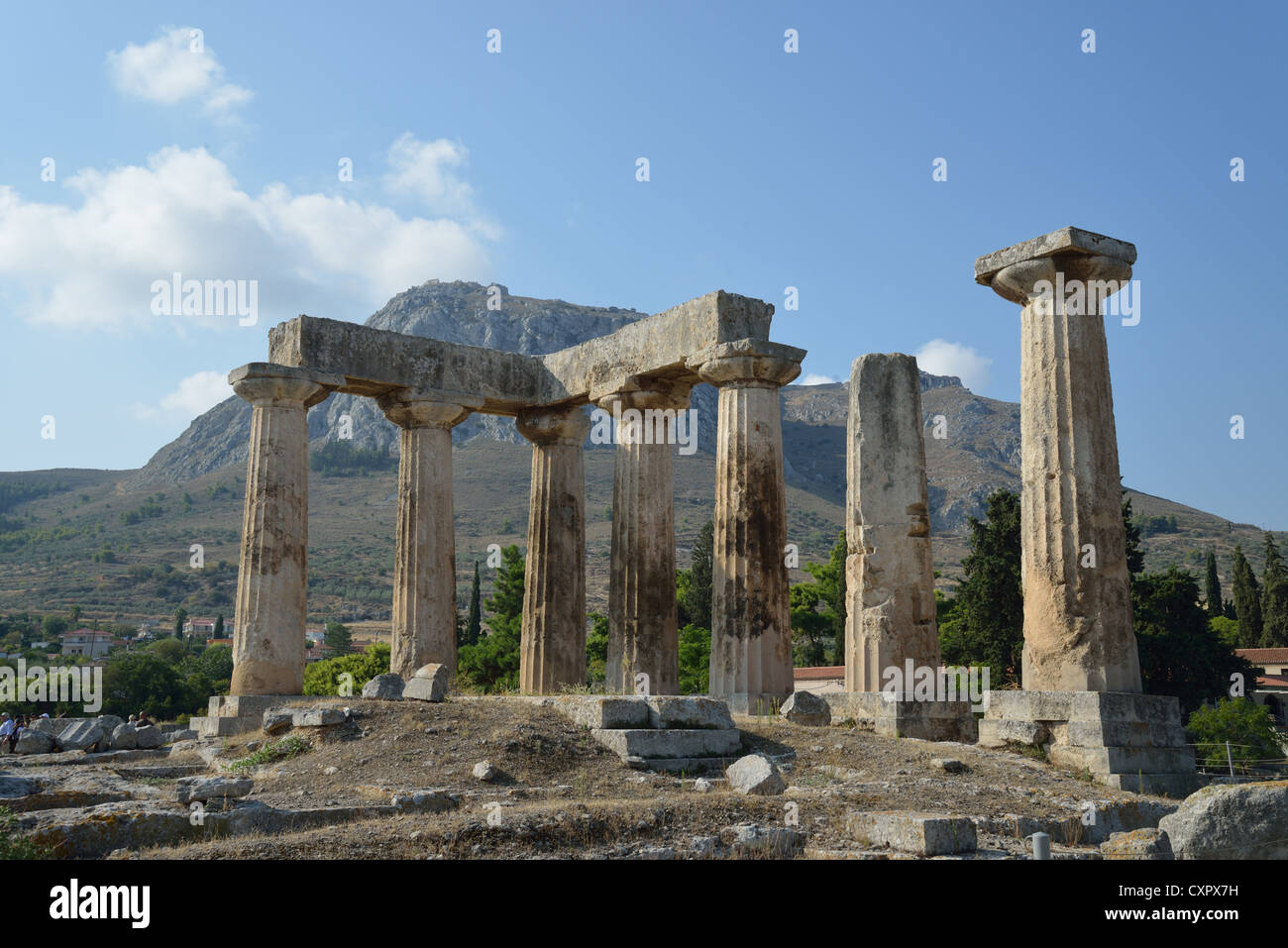 6th century BC Temple of Apollo with Acrocorinth Rock behind, Ancient Corinth, Corinth Municipality, Peloponnese region, Greece Stock Photo