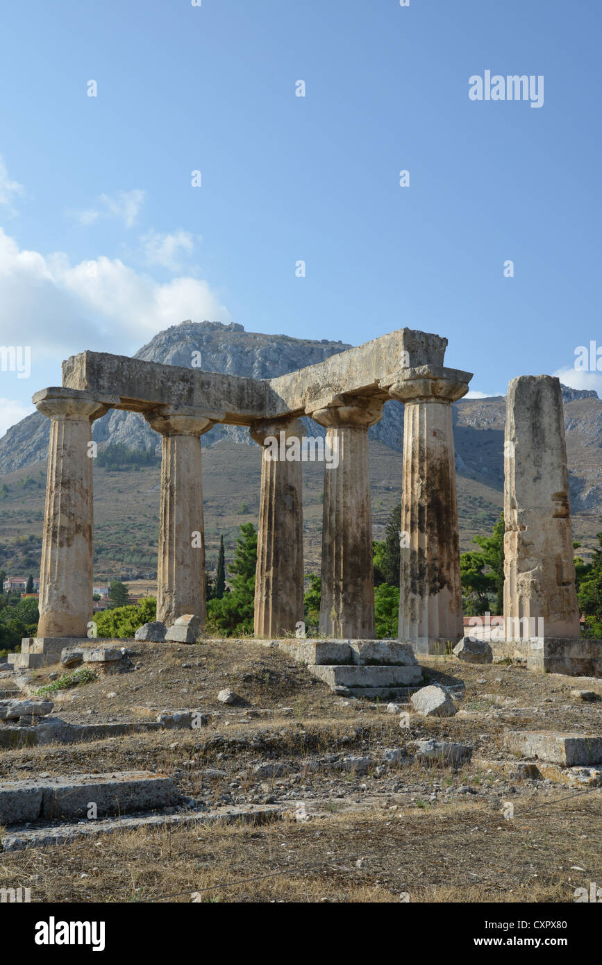 6th century BC Temple of Apollo with Acrocorinth Rock behind, Ancient Corinth, Corinth Municipality, Peloponnese region, Greece Stock Photo