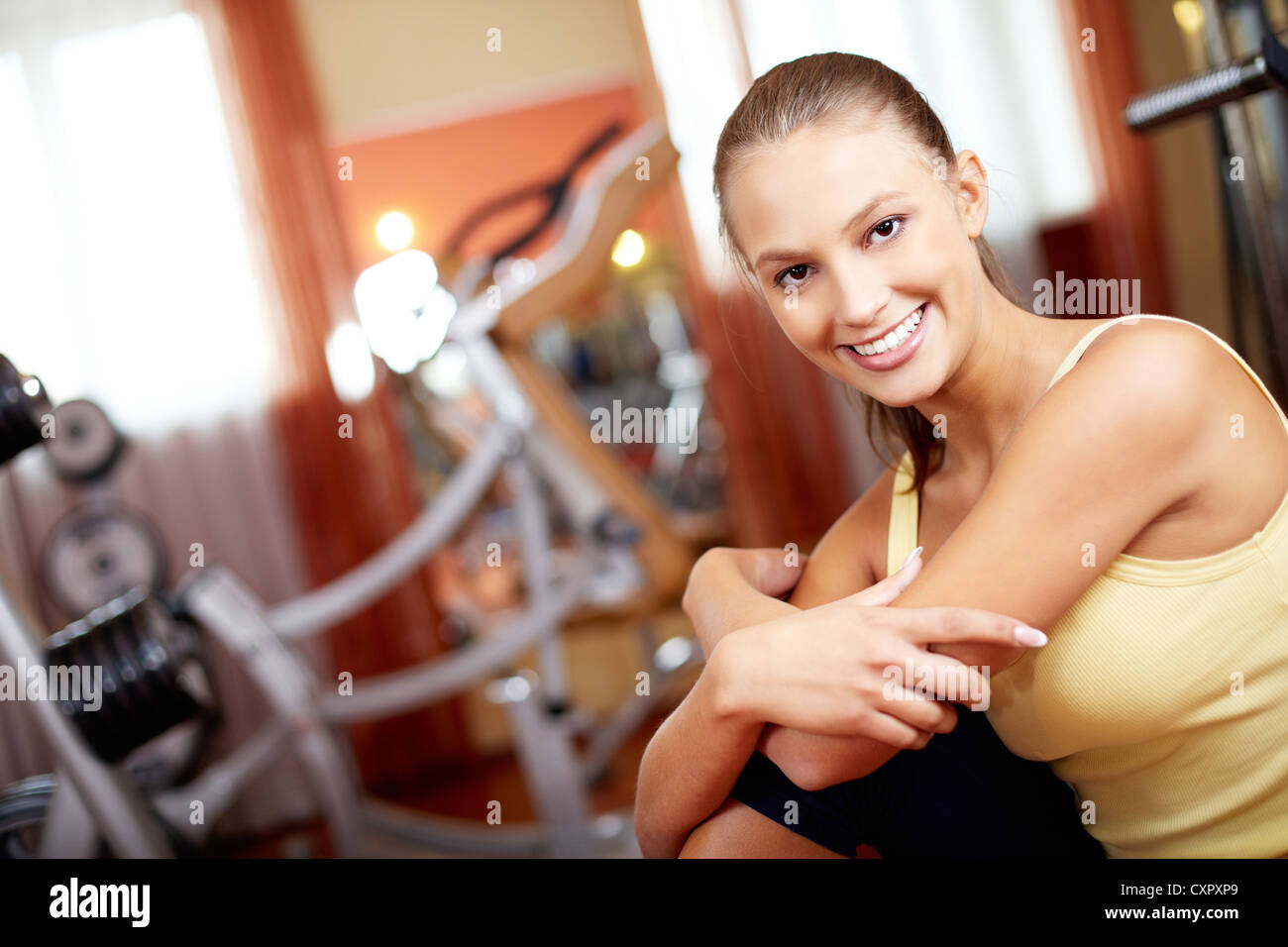 Portrait of pretty girl looking at camera with smile in gym Stock Photo ...