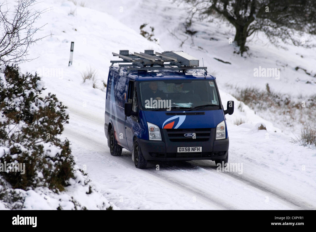 A British Gas van making its way along the mountain road in between Llangadog and Brynamman, South Wales in the snow. Stock Photo