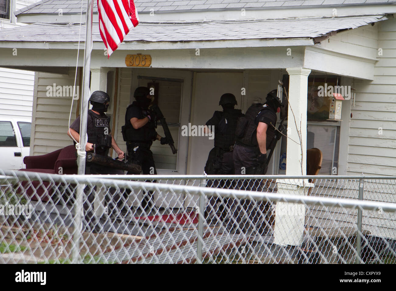 Police Tactical team serving high-risk narcotics related search warrant. Stock Photo
