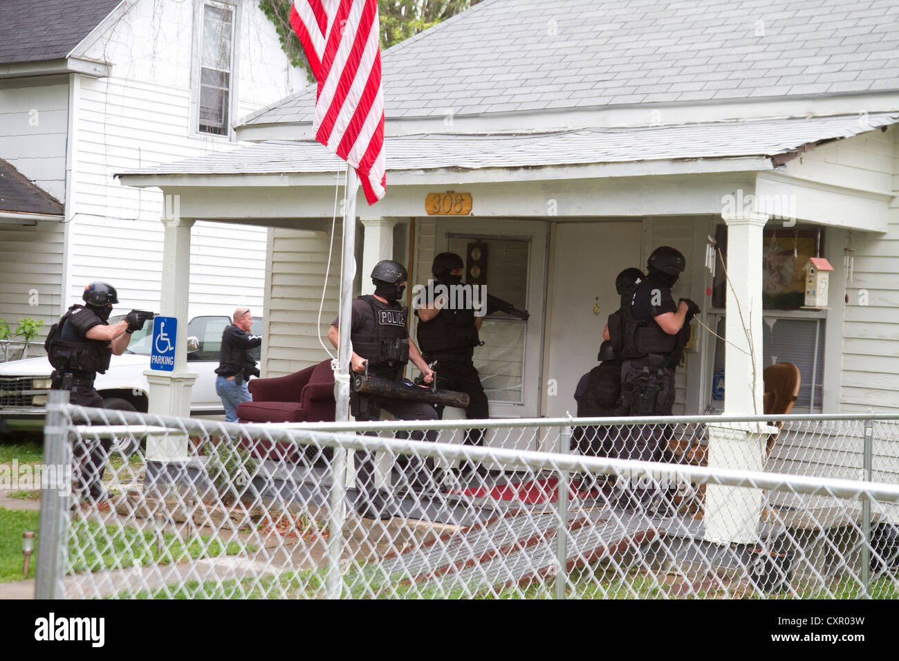 Police Tactical team serving high-risk narcotics related search warrant. Stock Photo