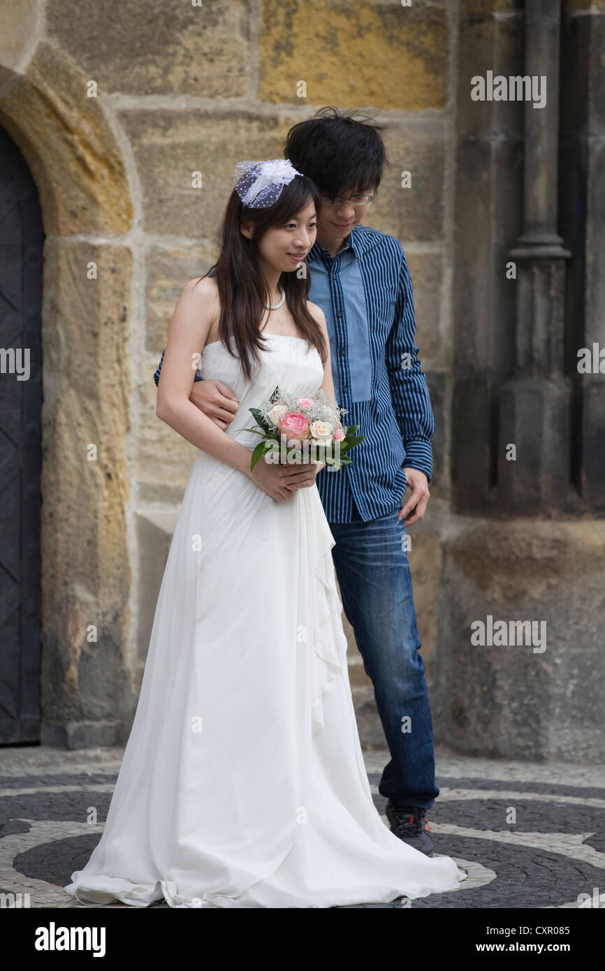 A Chinese couple just married in Prague at the  Astronomical Clock Stock Photo