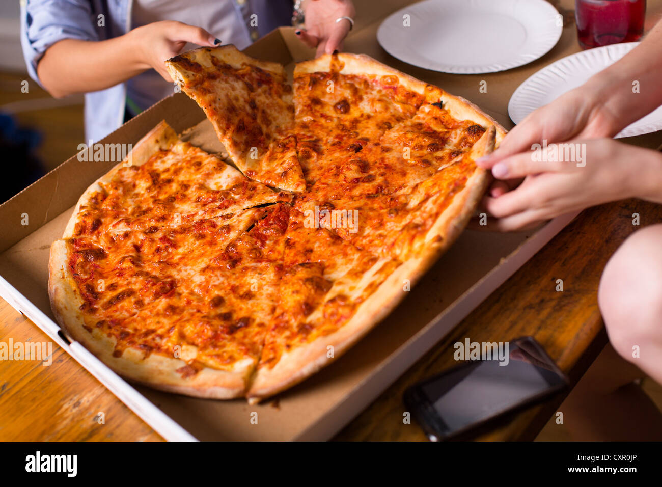 People sharing takeaway pizza Stock Photo