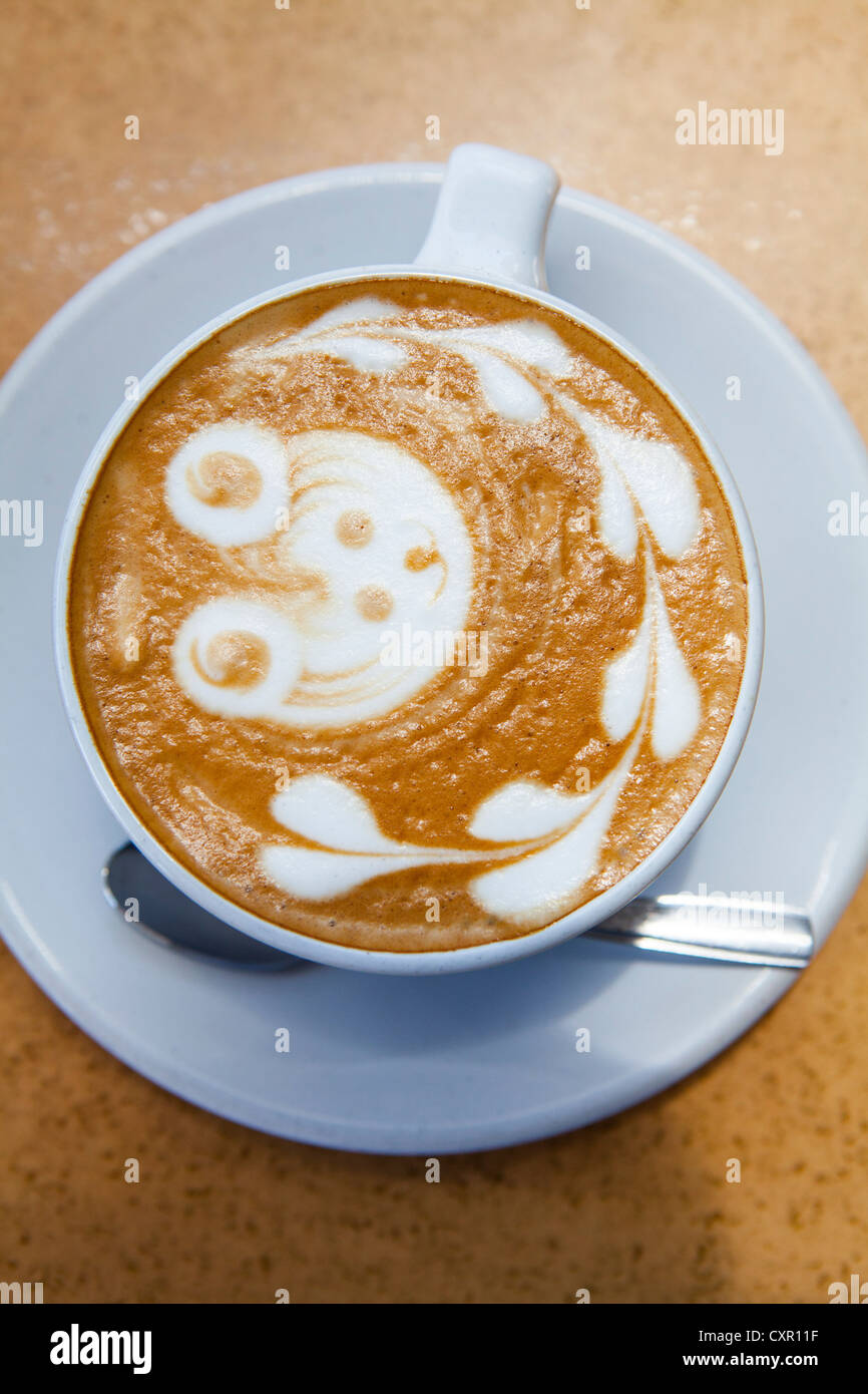 Teddy bear and heart shapes in coffee foam Stock Photo