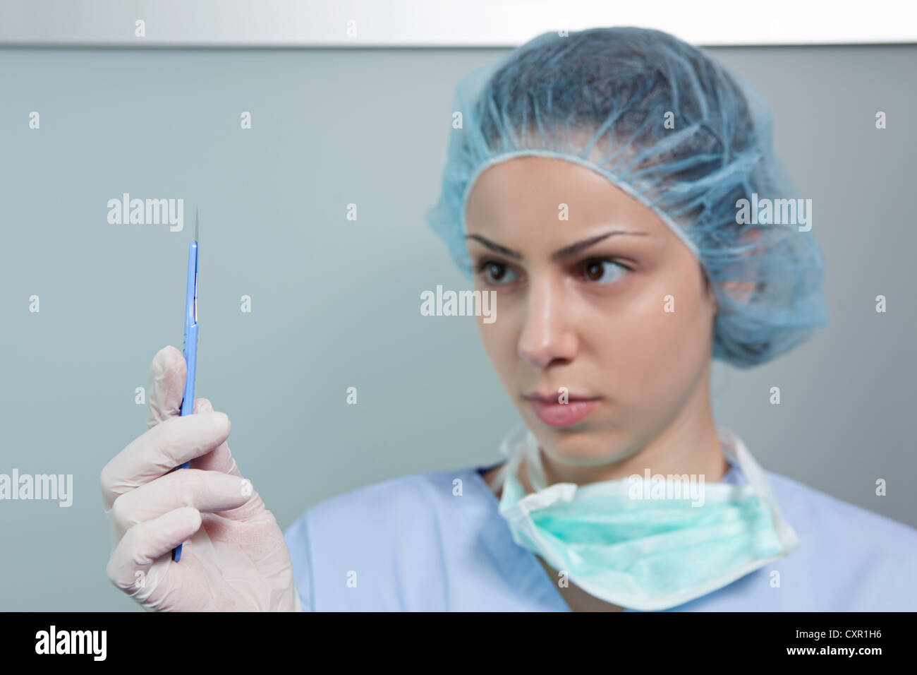 Surgeon holding scalpel Stock Photo