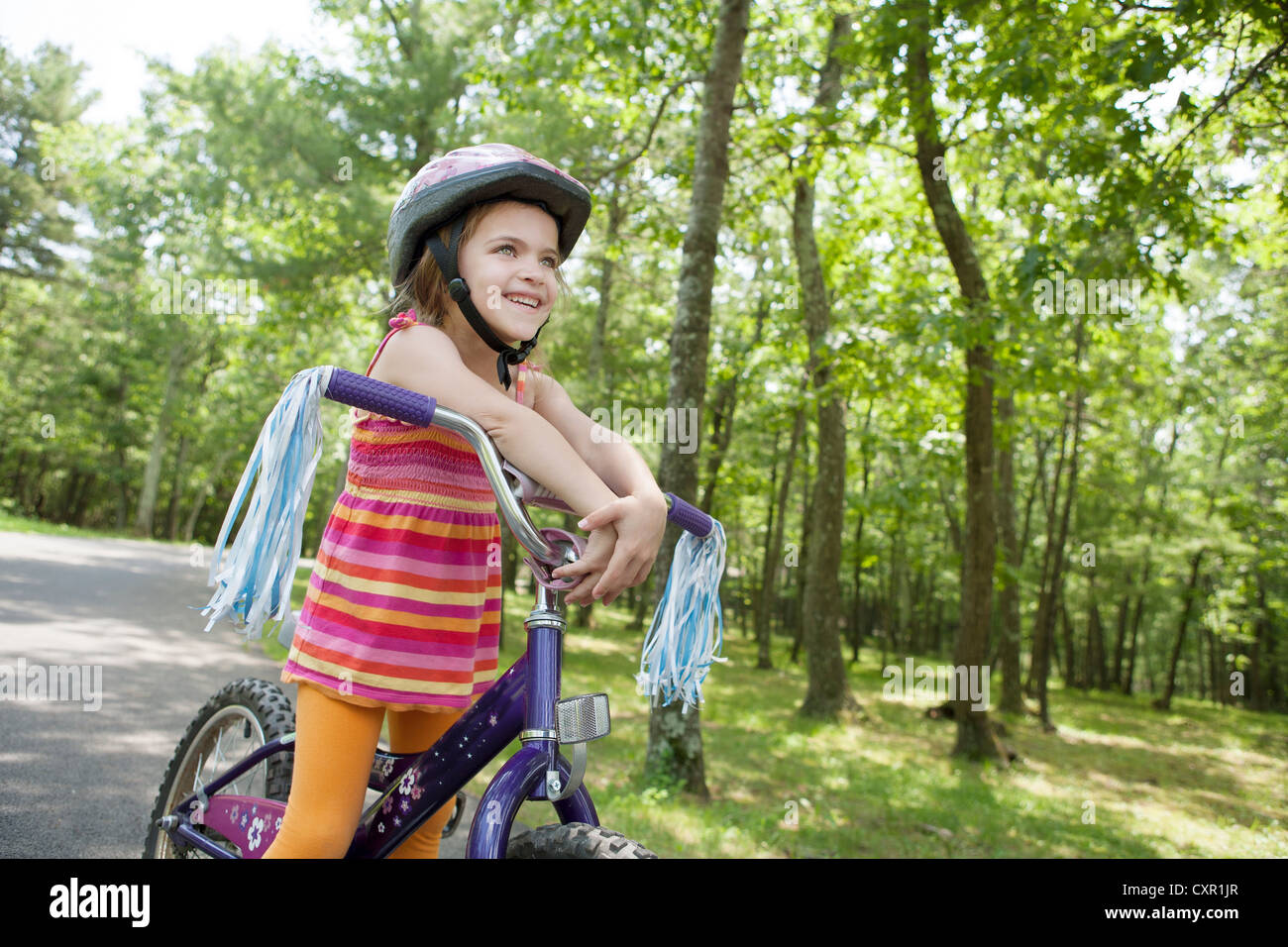 Girl leaning on bicycle handlebars Stock Photo Alamy