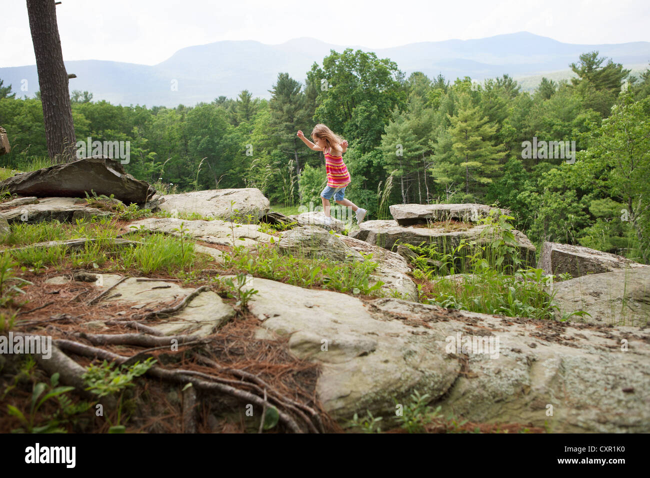 Girl playing on rocks Stock Photo