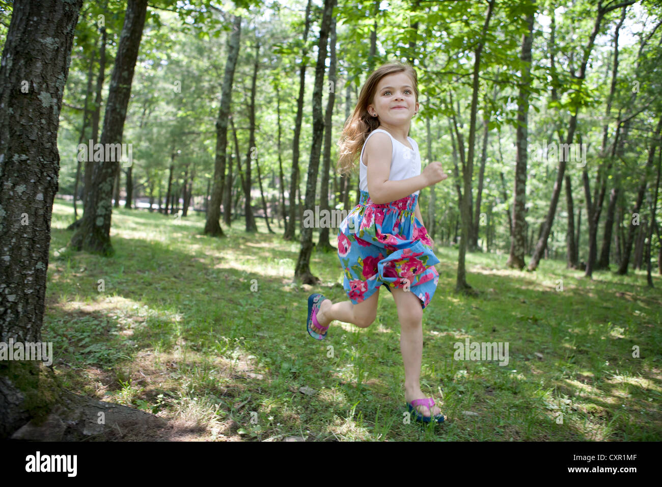 Girl running in forest Stock Photo