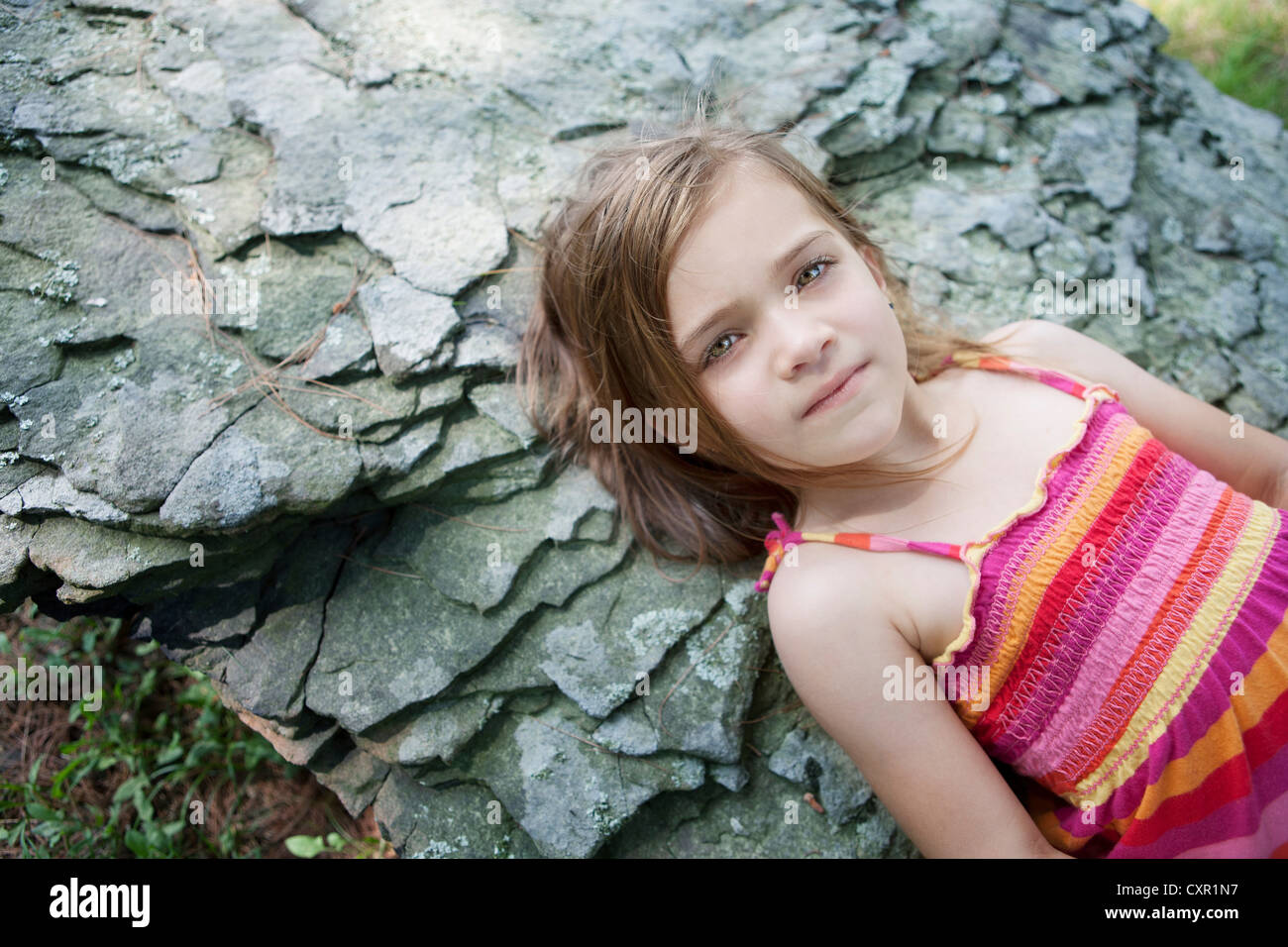 Girl lying on rocks Stock Photo