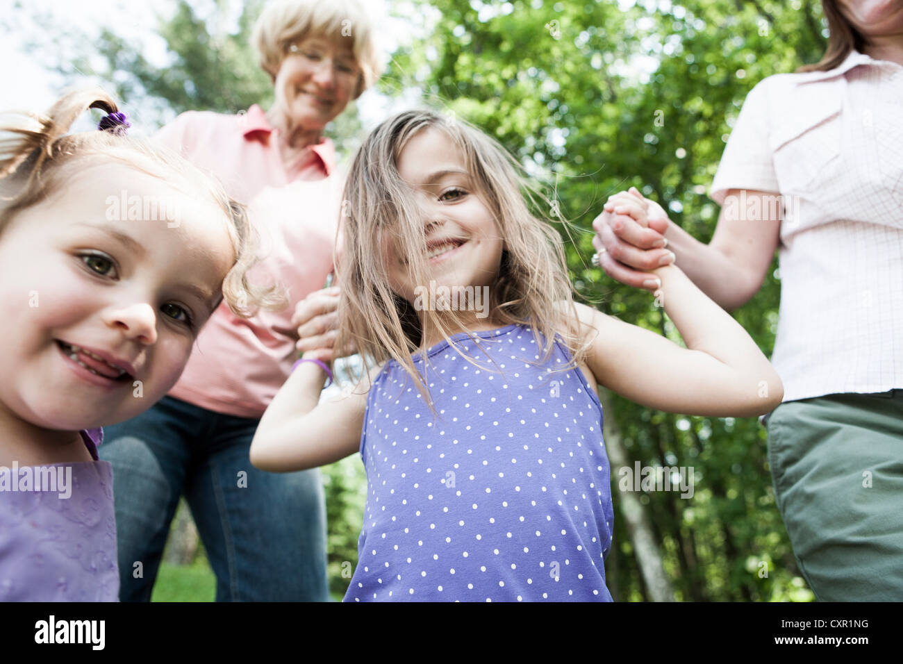 Three genration family holding hands, candid Stock Photo