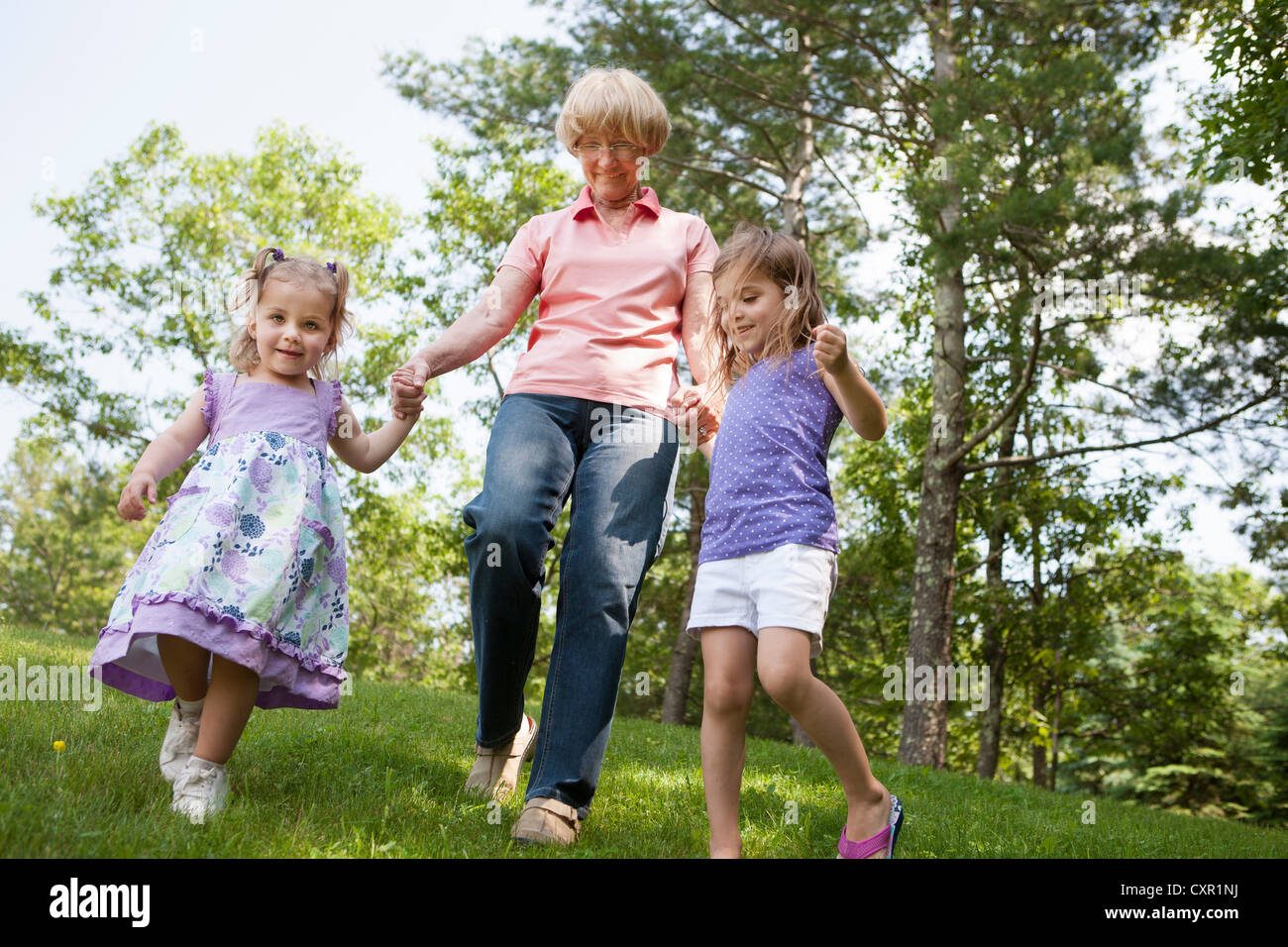 Grandmother and granddaughters holding hands Stock Photo