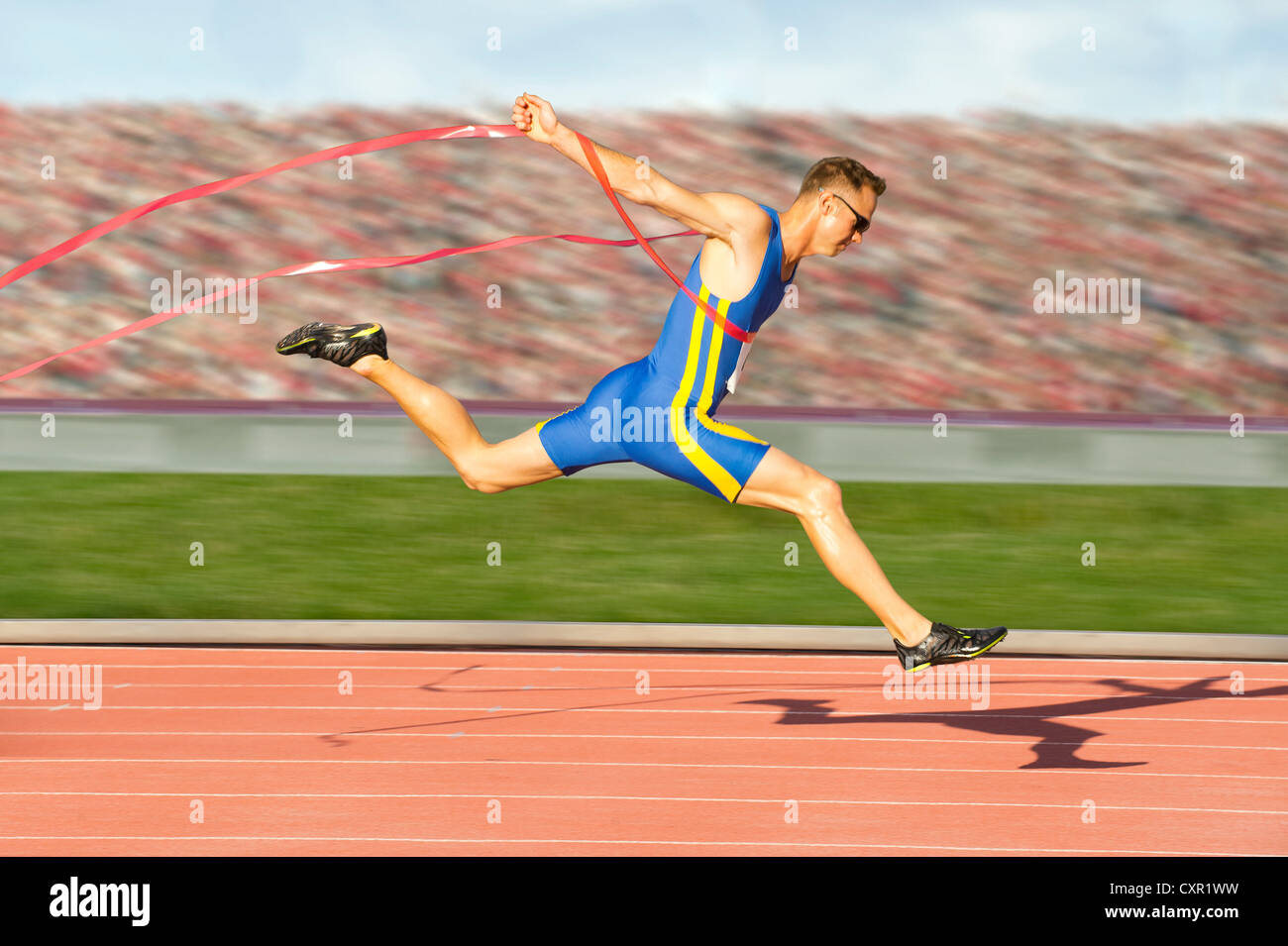 Runner crossing the finish line Stock Photo - Alamy