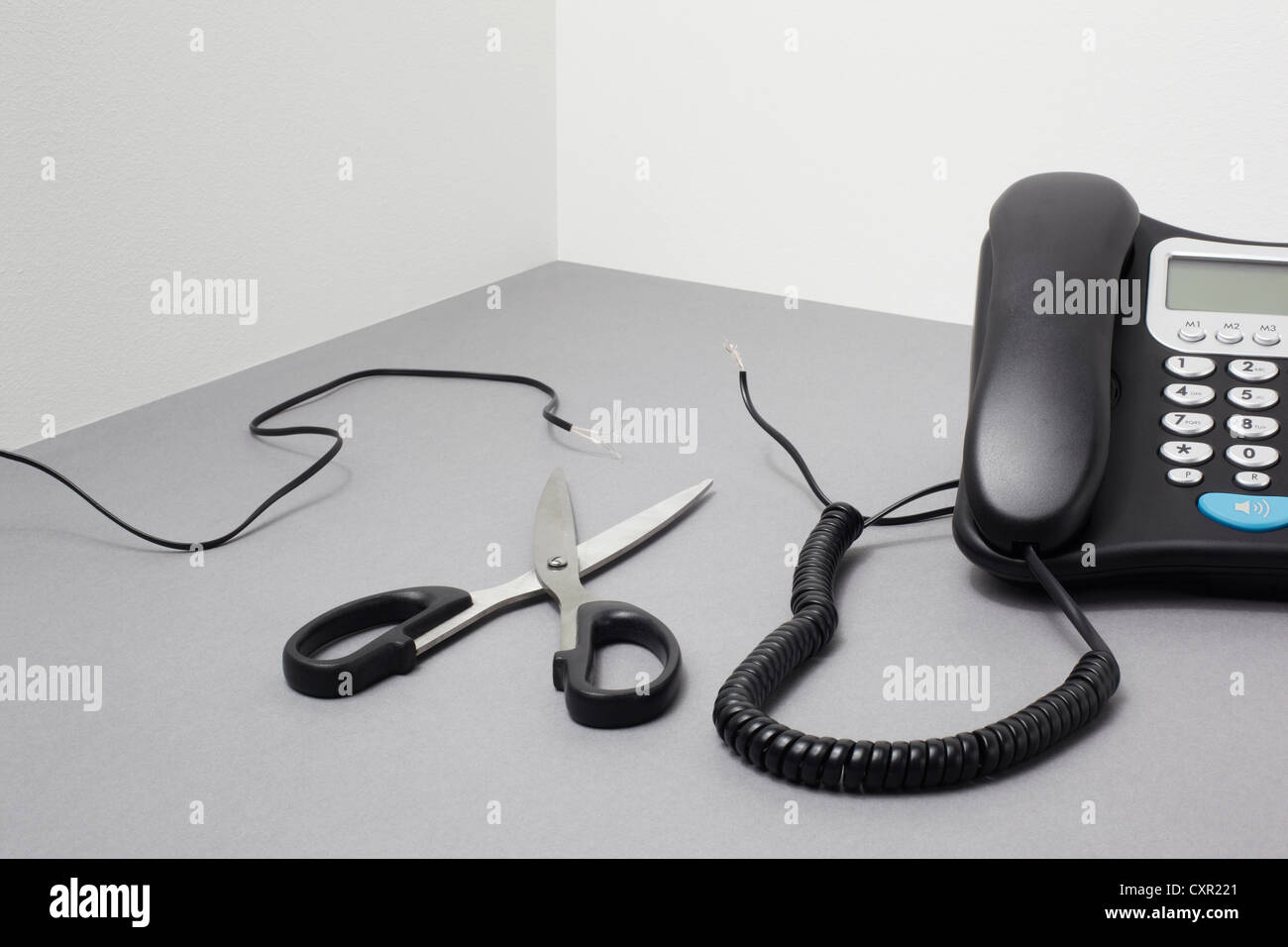 Landline phone, cut cable and scissors Stock Photo