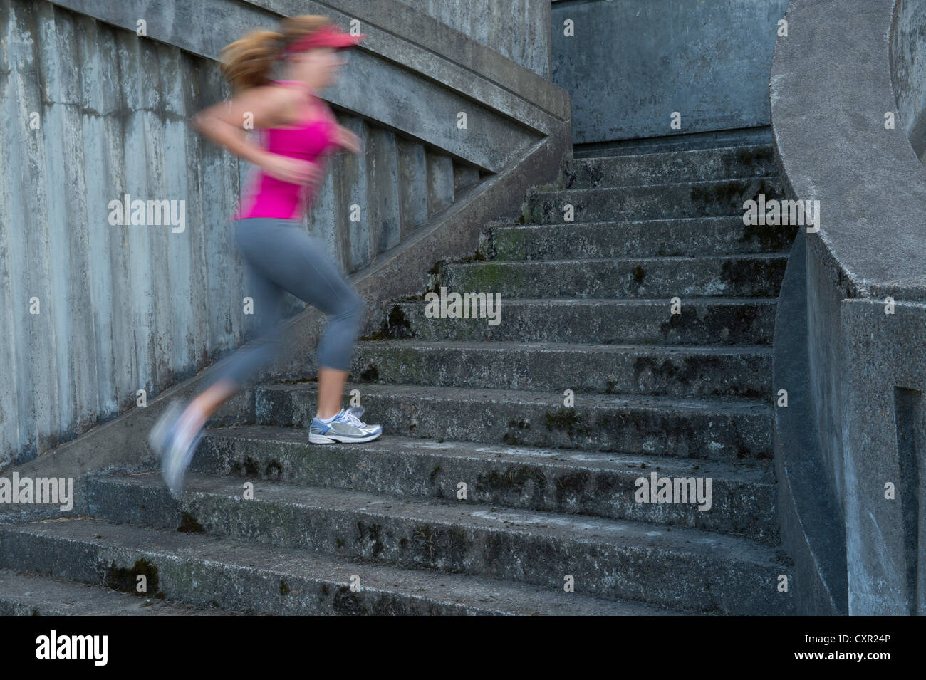 Young woman running up stairs, motion blur Stock Photo Alamy