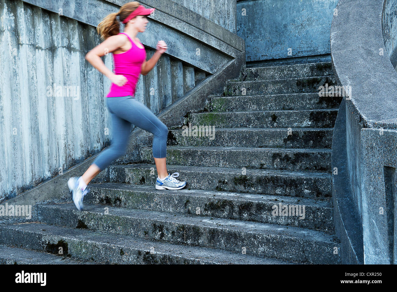 Young woman running up stairs Stock Photo Alamy