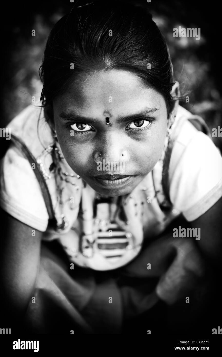 Intense Stare of a poor young Indian lower caste street girl. Black and white. Stock Photo