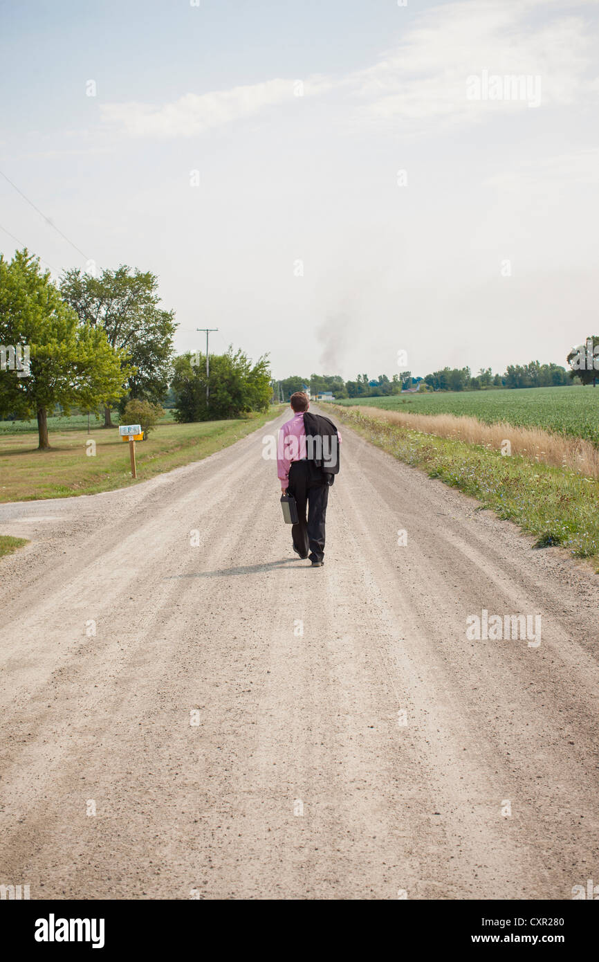 Man walking down dirt road hi-res stock photography and images - Alamy