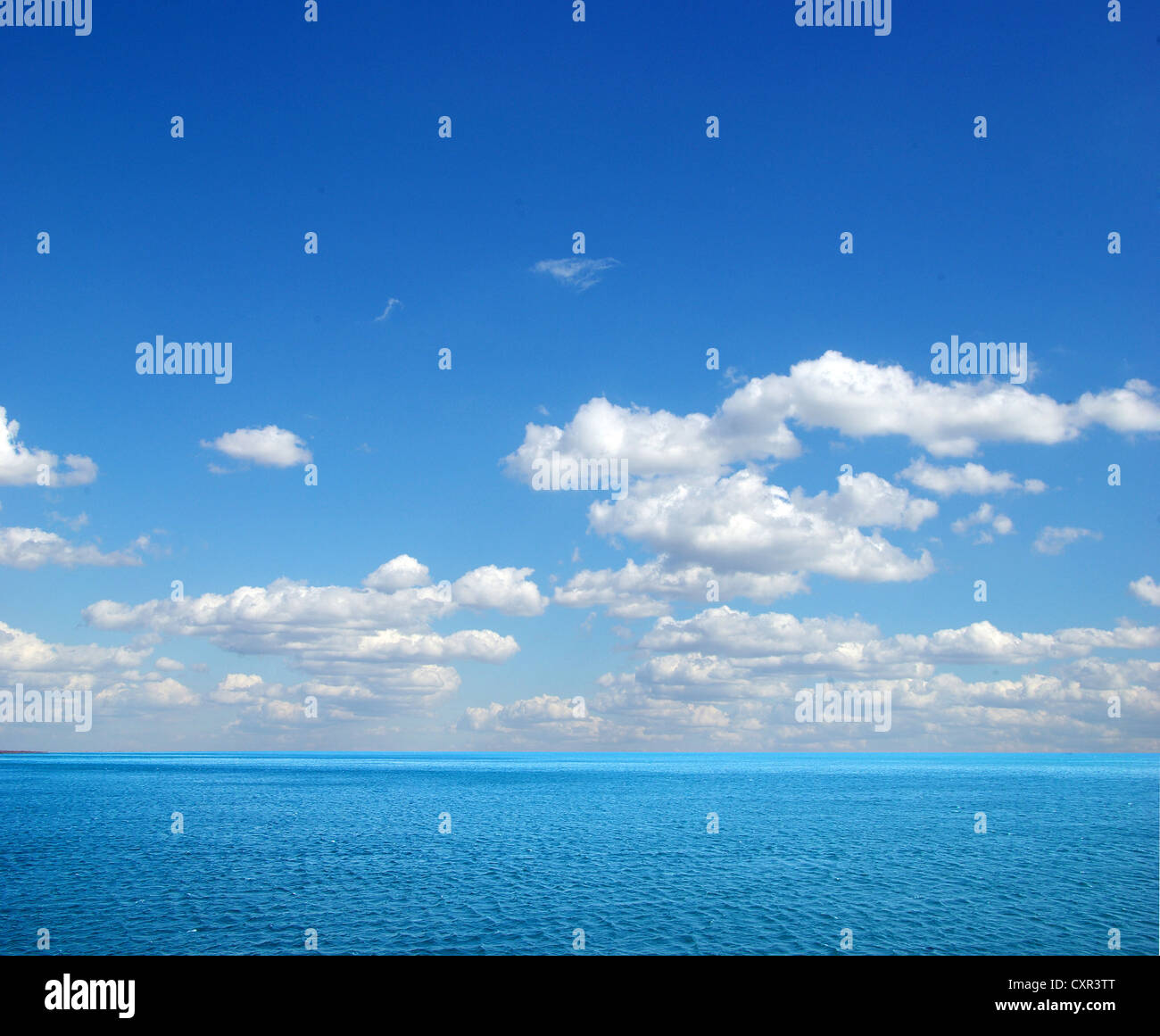 cloudy blue sky above a surface of the sea Stock Photo - Alamy