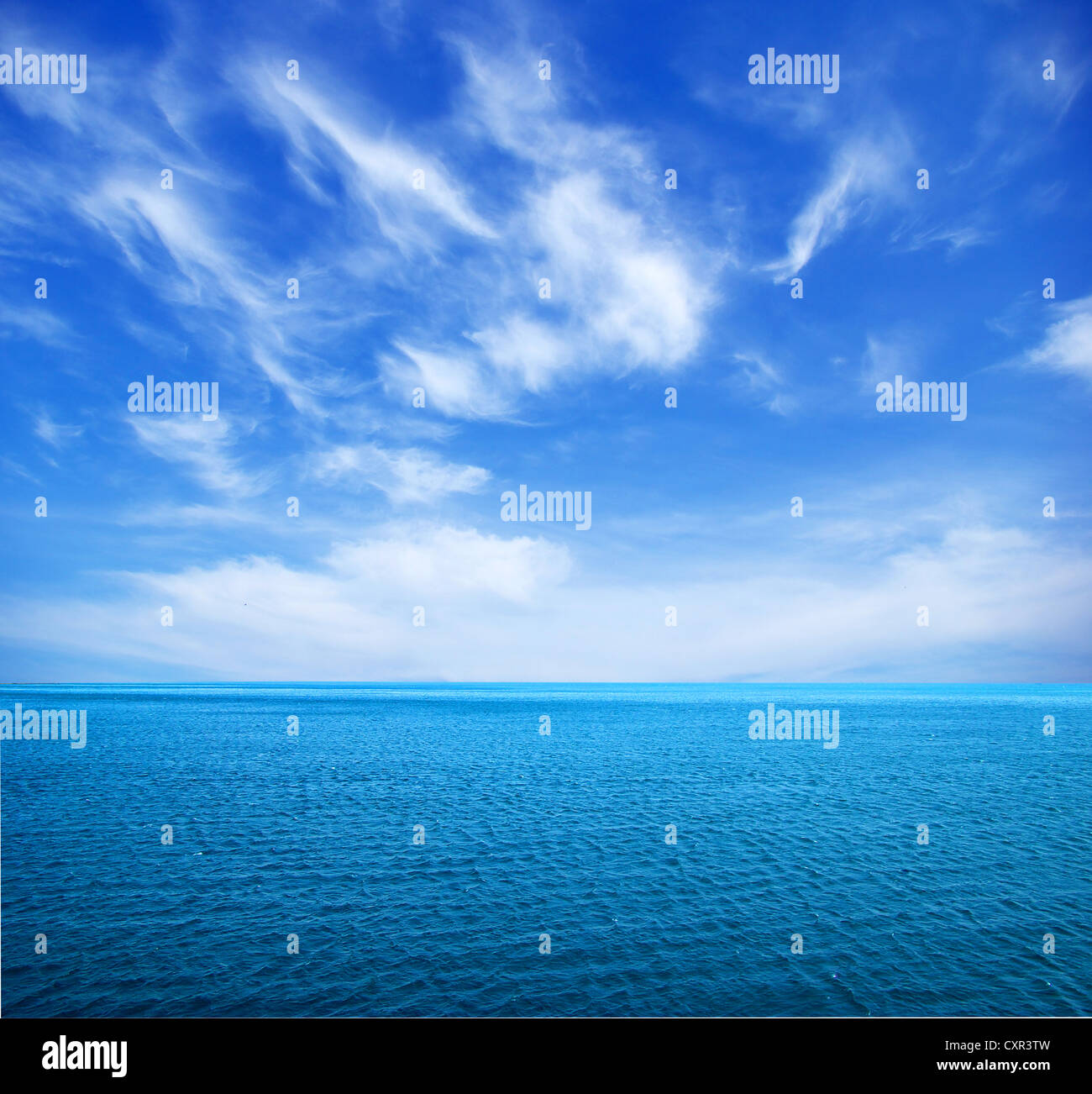 cloudy blue sky above a surface of the sea Stock Photo - Alamy