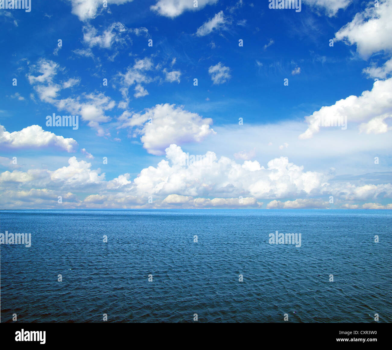 cloudy blue sky above a surface of the sea Stock Photo - Alamy