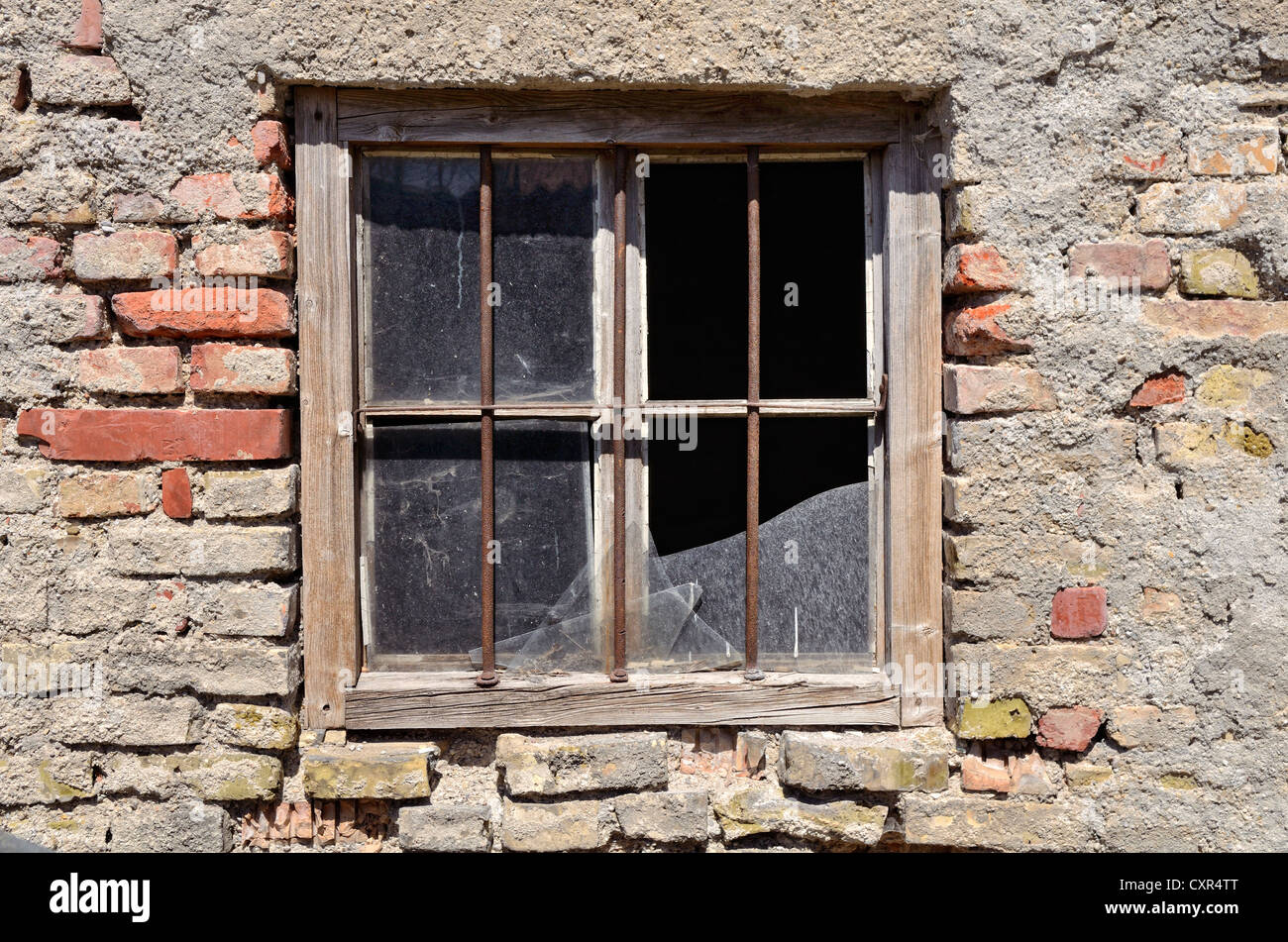 Stable with a barred broken window, brickwork made from Reichsformat or German format bricks, Miesbach, Upper Bavaria, Bavaria Stock Photo