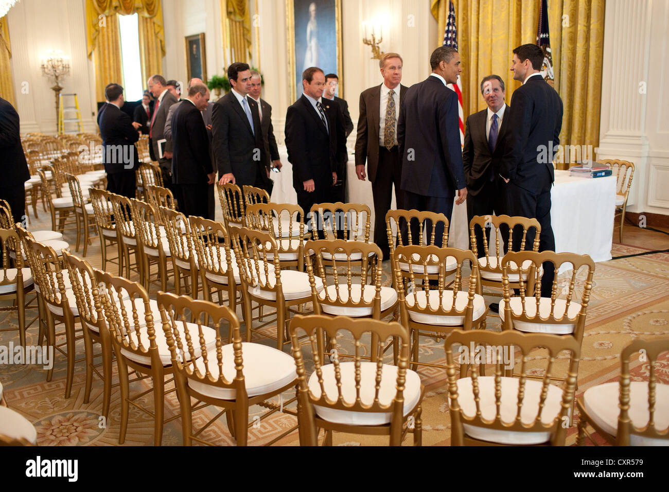 US President Barack Obama talks with House Budget Committee Chairman Paul Ryan (right) and National Economic Council Director Gene Sperling, second right, following a meeting with the Republican House Conference June 1, 2011 in the East Room of the White House. Stock Photo