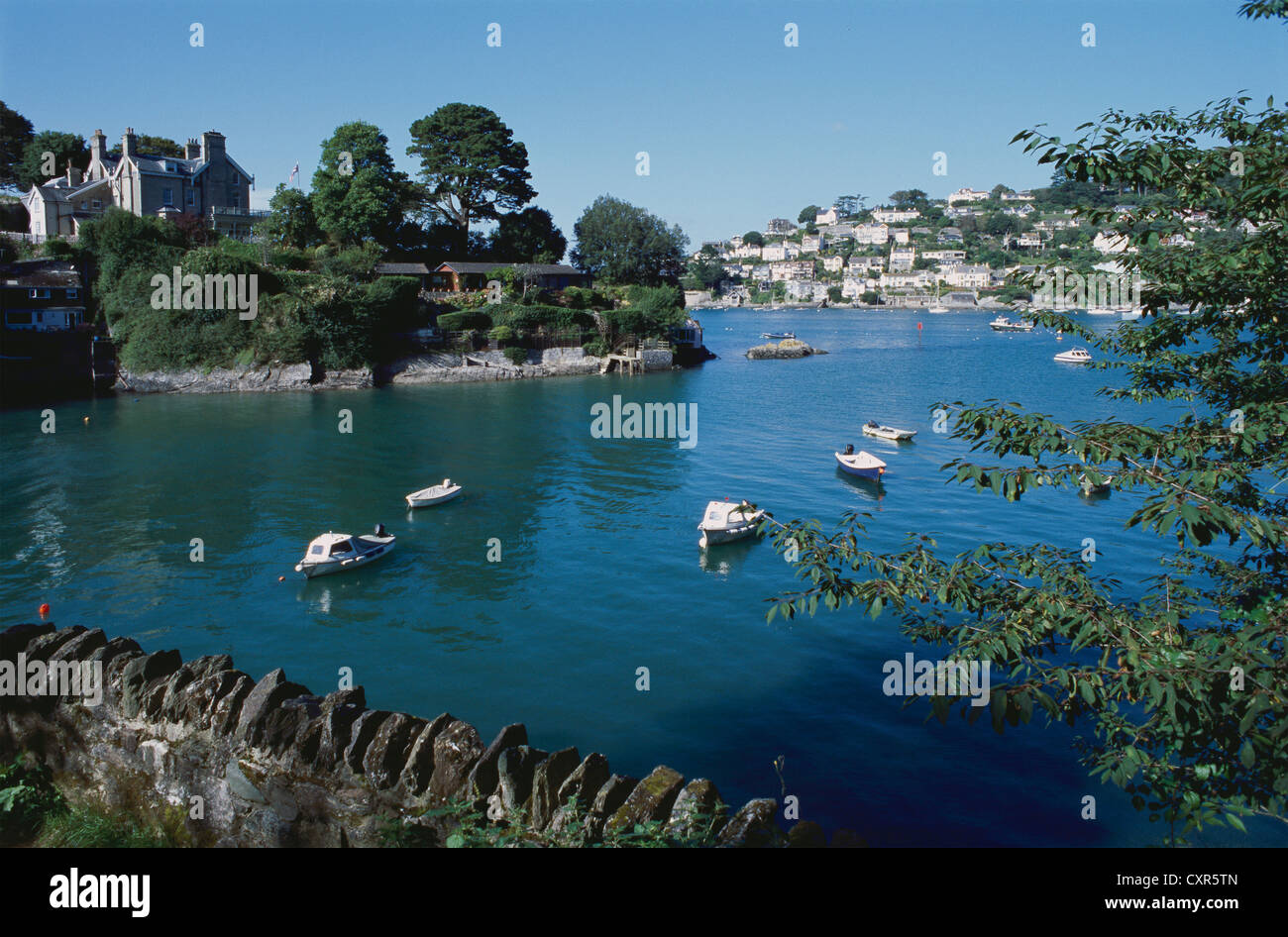Cove on the estuary of the River Dart,  near Dartmouth, Devon, South West England, in summer, with Kingswear in the background Stock Photo