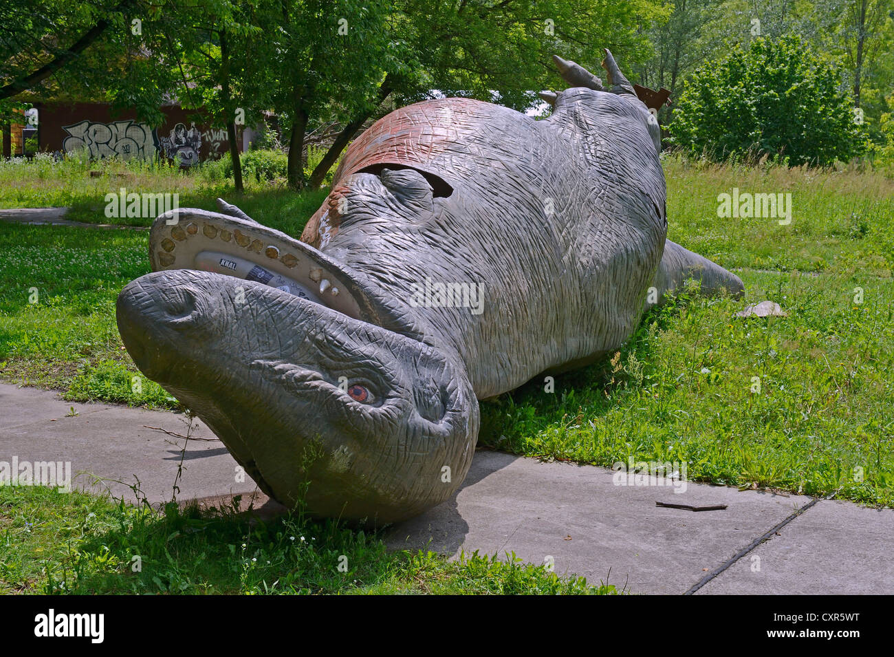 Dinosaur overturned by vandals, abandoned Spreepark Berlin amusement park, formerly known as Kulturpark Plaenterwald in the Stock Photo