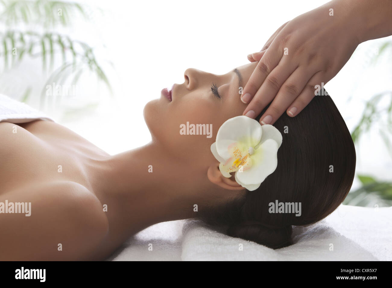 Young woman on massage table getting head massage Stock Photo