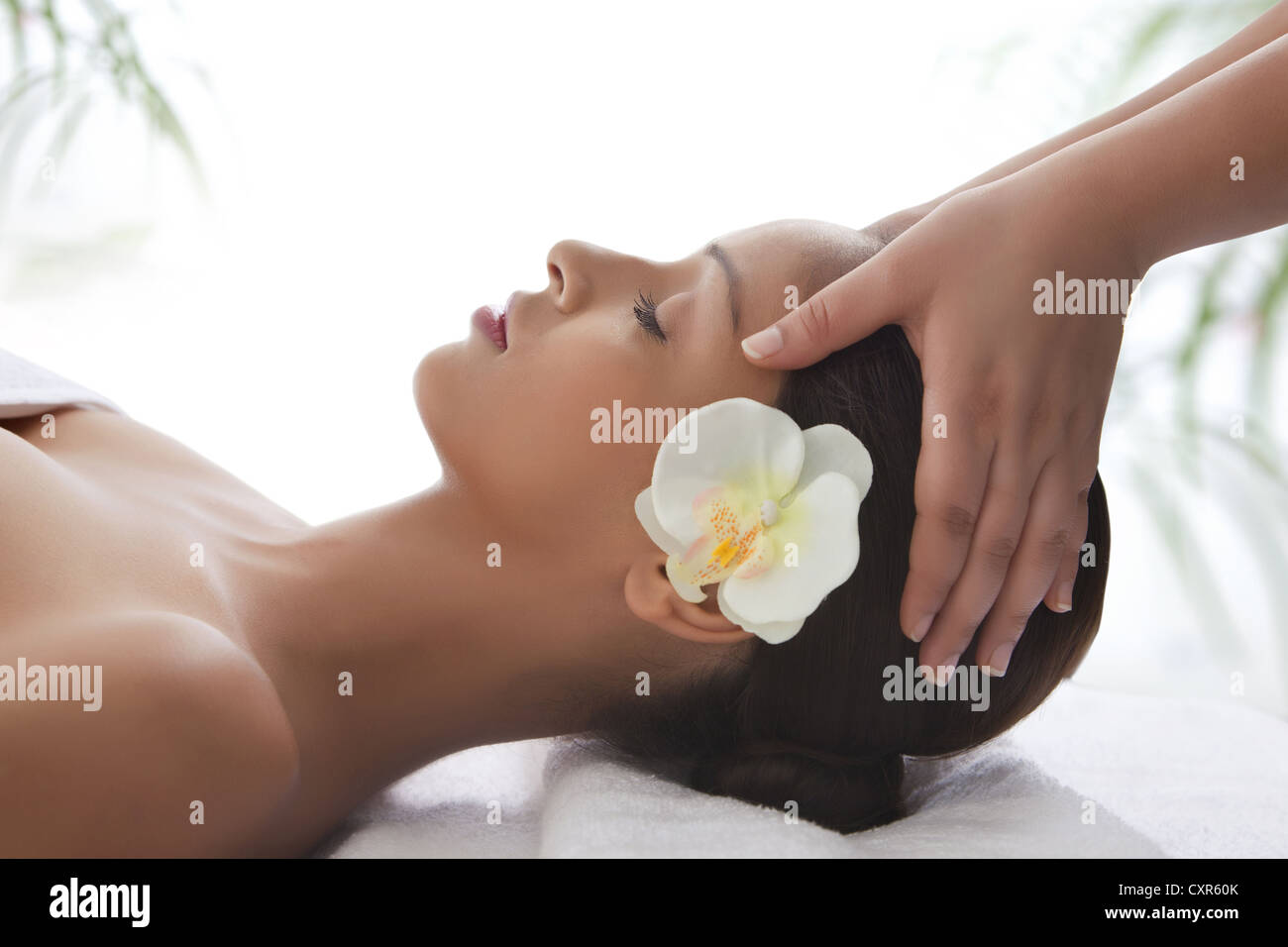 Side view of young woman on massage table getting head massage Stock Photo