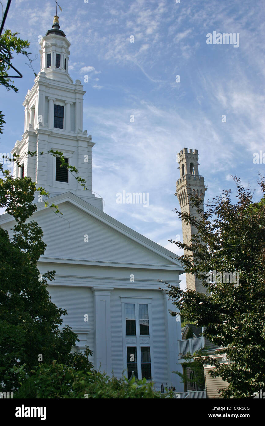 A view of a church and the Pilgrim Monument in Provincetown, Massachusetts Stock Photo