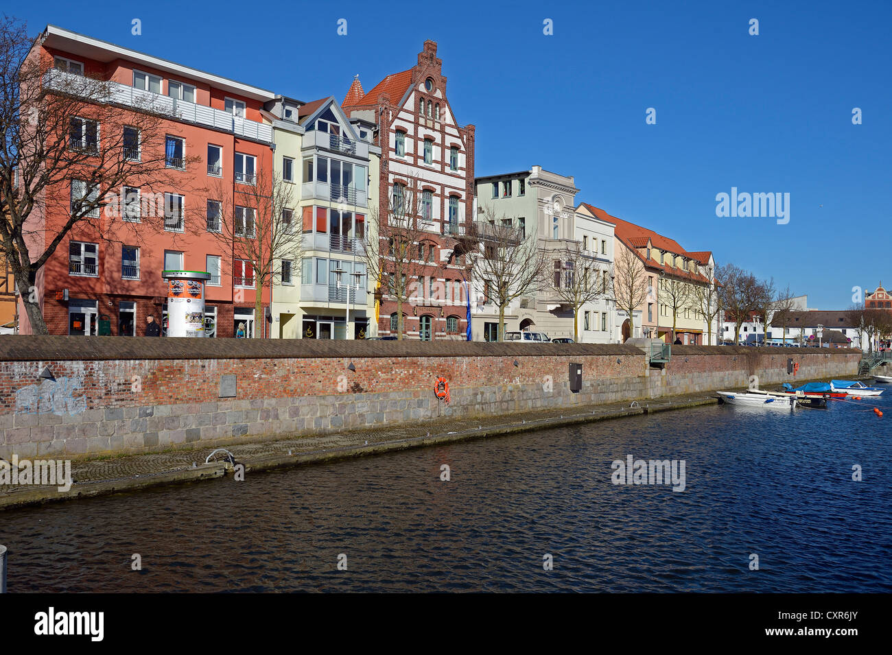 View of old brick buildings at Stralsund harbour as seen from Querkanal ...