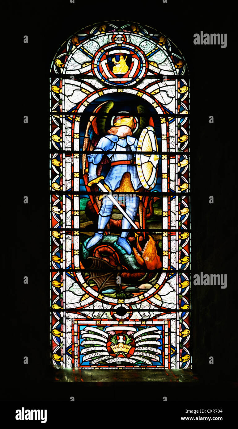 A Stained glass window depicting St George slaying the dragon, at Norwich Cathedral, England. Stock Photo