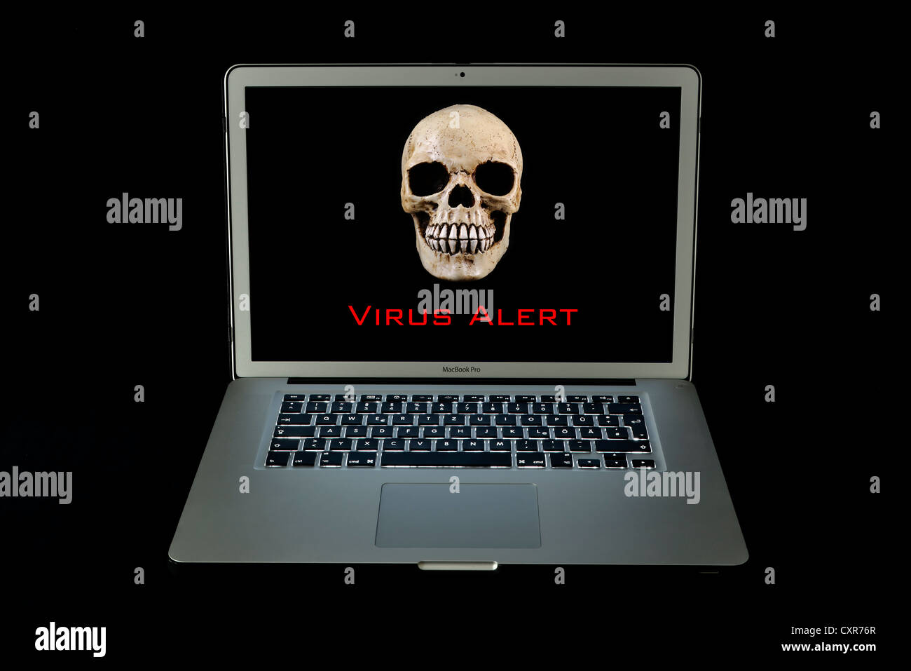 Skull, Apple MacBook Pro laptop computer, 'virus alert', virus warning Stock Photo