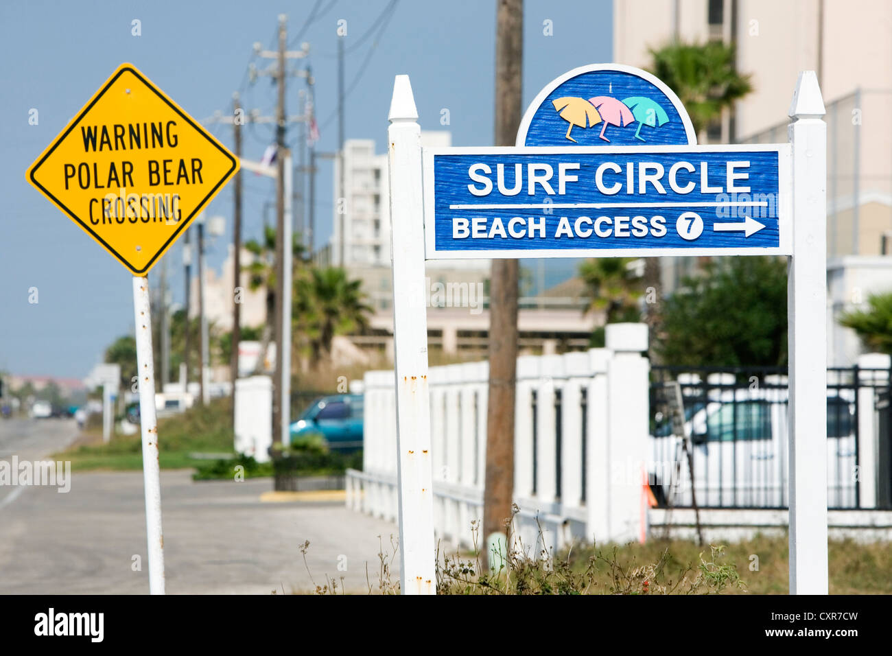Funny warning sign, lettering 'WARNING, POLAR BEAR CROSSING' and a sign, lettering 'beach access', South Padre Iceland, Texas Stock Photo