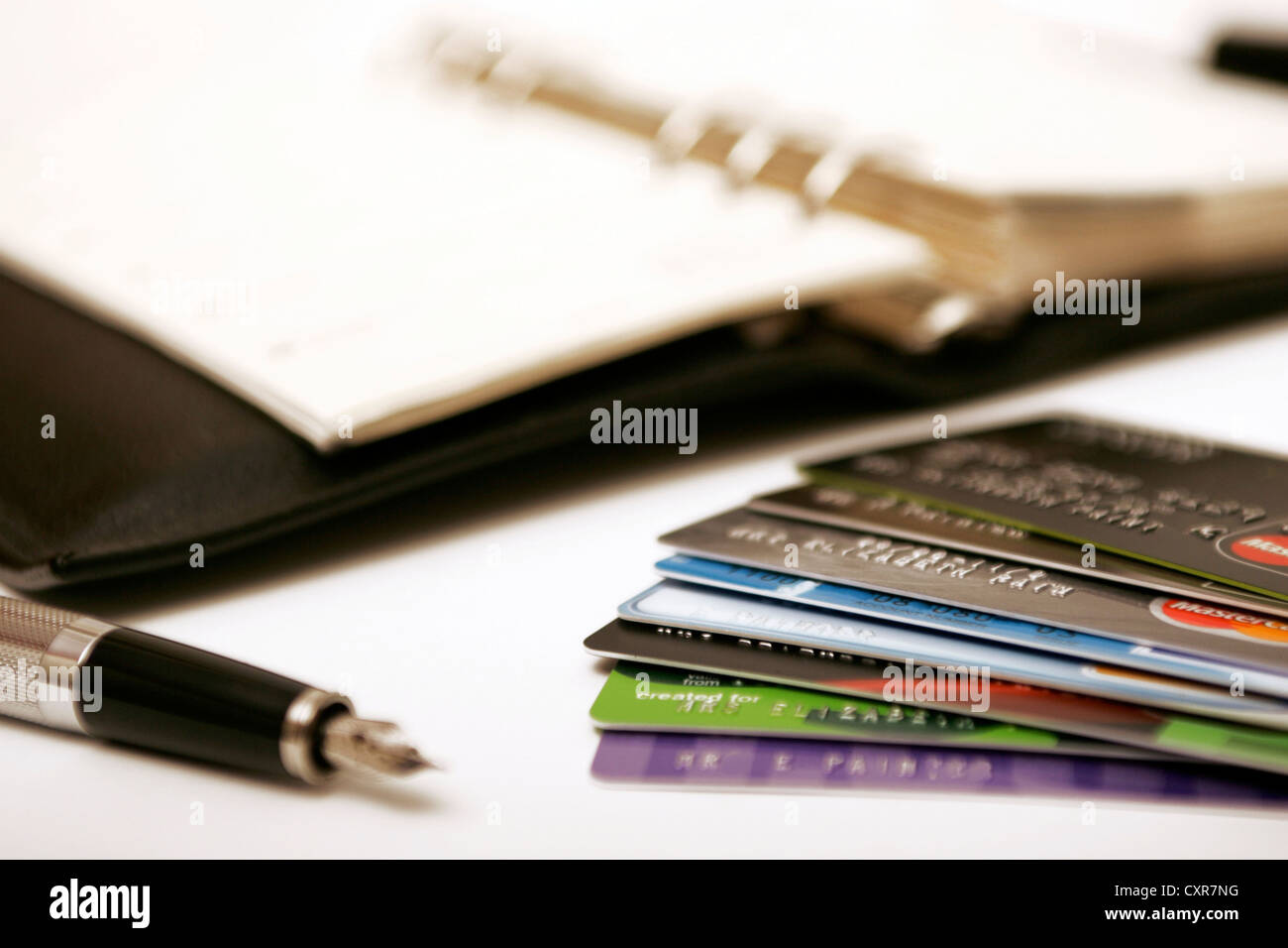 Organizer, pen and credit debit cards organization of debts writing payments in diary, bills to pay Stock Photo