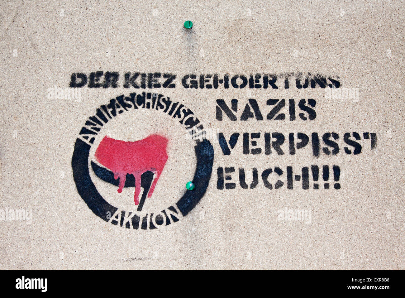 Stencil 'Der Kiez gehoert uns, Nazis, verpisst Euch!!!', German for 'this neighbourhood is ours, Nazis get lost' Stock Photo