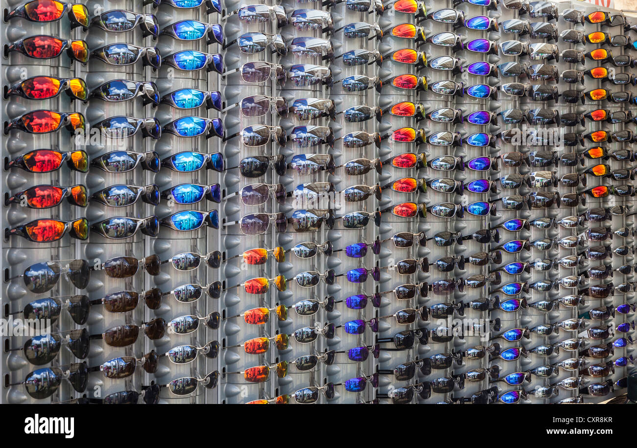 DISPLAY STAND OF SUN GLASSES WITH DIFFERENT COLOURED/COLORED LENSES IN OPTICIAN'S SHOP UK Stock Photo