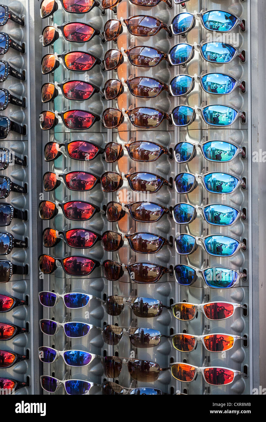 DISPLAY STAND OF SUN GLASSES WITH DIFFERENT COLOURED/COLORED LENSES IN OPTICIAN'S SHOP UK Stock Photo