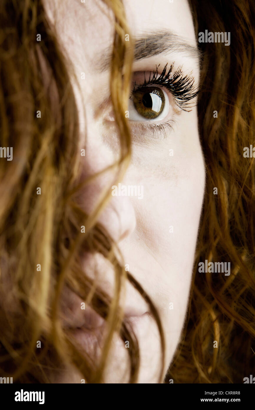 Woman with a strand of hair in front of her face, portrait Stock Photo